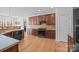 Well-equipped kitchen featuring wooden cabinetry, tile backsplash, and modern appliances, ready for culinary adventures at 1221 Cochrane Woods Ln, Matthews, NC 28105