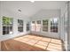 Sun-drenched sunroom featuring vaulted ceilings, hardwood floors, and expansive windows overlooking the outdoors at 1221 Cochrane Woods Ln, Matthews, NC 28105