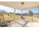 Relaxing back porch with rocking chairs and view of backyard at 1243 Glory Ct, Oakboro, NC 28129