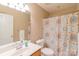 Clean bathroom with single vanity, decorative shower curtain, and neutral tones at 1243 Glory Ct, Oakboro, NC 28129