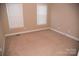 Simple bedroom with carpet flooring and two windows at 1243 Glory Ct, Oakboro, NC 28129