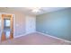 Bedroom with neutral walls, carpet, and double-door closet at 1243 Glory Ct, Oakboro, NC 28129