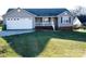 Ranch style home with attached garage and landscaped lawn at 1243 Glory Ct, Oakboro, NC 28129