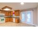 Kitchen featuring wood cabinets, tile floors, and white appliances at 1243 Glory Ct, Oakboro, NC 28129