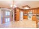 Bright kitchen boasts wood cabinetry, granite counters & views into adjacent living room at 1243 Glory Ct, Oakboro, NC 28129