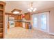 Kitchen features wood cabinets, white appliances, and French doors to patio at 1243 Glory Ct, Oakboro, NC 28129