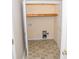 Small laundry room with built-in shelving and tile floor at 1243 Glory Ct, Oakboro, NC 28129