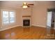 Living room with hardwood floors, fireplace, and high ceiling at 1243 Glory Ct, Oakboro, NC 28129