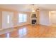 Living room with hardwood floors, fireplace, and access to kitchen at 1243 Glory Ct, Oakboro, NC 28129