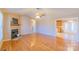 Open concept living room with hardwood floors and kitchen access at 1243 Glory Ct, Oakboro, NC 28129