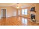 Bright living room featuring hardwood floors, a fireplace, and neutral paint throughout at 1243 Glory Ct, Oakboro, NC 28129