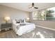 Bright bedroom with a queen-size bed, large windows, and hardwood floors at 1300 Reece Rd # G-18, Charlotte, NC 28209