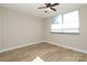 Simple bedroom with hardwood floors and a ceiling fan at 1300 Reece Rd # G-18, Charlotte, NC 28209