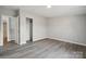 Bedroom with gray floors, a closet, neutral walls, and an open doorway at 137 S Penny St, Lancaster, SC 29720