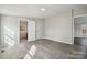 Bedroom with neutral walls, gray floors, and an open doorway at 137 S Penny St, Lancaster, SC 29720