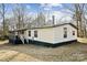 Charming single-story home with yellow siding and a screened in porch at 137 S Penny St, Lancaster, SC 29720