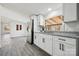 Bright kitchen featuring modern appliances, gray wood floors, and granite countertops at 137 S Penny St, Lancaster, SC 29720