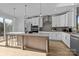 Modern kitchen with white cabinets, an island, and stainless steel appliances at 14028 Felix Ln # 3, Charlotte, NC 28277