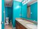 Teal bathroom with double vanity and toilet at 145 Ashton Woods Ct, Mount Holly, NC 28120