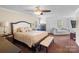 Bright bedroom featuring a plush bed and sitting area at 145 Ashton Woods Ct, Mount Holly, NC 28120