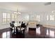 Bright dining room featuring hardwood floors and a glass-top table at 145 Ashton Woods Ct, Mount Holly, NC 28120