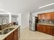 Kitchen features granite countertops, stainless steel appliances, and herringbone tile floor at 145 Ashton Woods Ct, Mount Holly, NC 28120