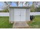 Detached storage shed in backyard with double doors at 145 Ashton Woods Ct, Mount Holly, NC 28120