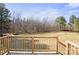 View from a wooden deck into a big, verdant backyard with mature trees and a clear sky at 145 Morcroft Ln, Cleveland, NC 27013