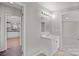 Bathroom featuring a single sink vanity with a mirror, a light fixture and a view into another room at 145 Morcroft Ln, Cleveland, NC 27013