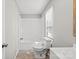 A bathroom featuring a white toilet, bathtub, and vanity with natural light from the window at 145 Morcroft Ln, Cleveland, NC 27013