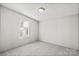 A cozy bedroom featuring a window and neutral-colored walls and carpet at 145 Morcroft Ln, Cleveland, NC 27013