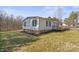 Exterior view of a single story house with a wooden deck and manicured lawn at 145 Morcroft Ln, Cleveland, NC 27013