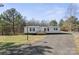 Inviting single-story residence showcasing a well-manicured lawn and a gravel driveway at 145 Morcroft Ln, Cleveland, NC 27013