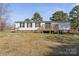 Rear view of a single story house with a wooden deck and manicured lawn at 145 Morcroft Ln, Cleveland, NC 27013