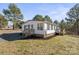 Charming single-story home featuring a well-maintained yard, wooden deck and classic white siding at 145 Morcroft Ln, Cleveland, NC 27013