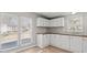 Kitchen featuring white cabinets, wood look flooring and windows overlooking the property at 145 Morcroft Ln, Cleveland, NC 27013