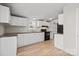 Bright kitchen featuring white cabinets, black appliances, and wood look flooring at 145 Morcroft Ln, Cleveland, NC 27013