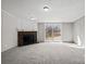 Spacious living room featuring neutral walls and floors, a fireplace, and sliding glass door to the rear patio at 145 Morcroft Ln, Cleveland, NC 27013