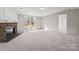 Bright room featuring neutral walls and flooring, a fireplace, and sliding glass door to the rear patio at 145 Morcroft Ln, Cleveland, NC 27013