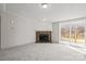 Neutral living room featuring neutral walls and floors, a fireplace, and sliding glass door to the rear patio at 145 Morcroft Ln, Cleveland, NC 27013