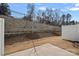 Backyard with a concrete patio and retaining wall, offering a private outdoor space at 16022 Red Buckeye Ln, Huntersville, NC 28078