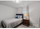 Cozy bedroom featuring a comfortable bed, soft lighting, and a window with natural light at 16022 Red Buckeye Ln, Huntersville, NC 28078