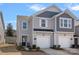 Charming townhome showcasing a well-maintained front yard and a single-car garage, ideal for modern living at 16022 Red Buckeye Ln, Huntersville, NC 28078