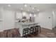 Modern kitchen featuring pendant lighting, a granite island, stainless steel appliances and hardwood floors at 16022 Red Buckeye Ln, Huntersville, NC 28078