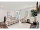 Cozy living room featuring a fireplace, recessed lighting and hardwood floors at 16022 Red Buckeye Ln, Huntersville, NC 28078