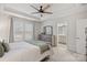 Comfortable main bedroom showcasing neutral tones, large windows, and adjoining bathroom at 16022 Red Buckeye Ln, Huntersville, NC 28078