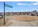 Street view of neighborhood, showcasing a well-maintained common area and inviting streetscape at 16022 Red Buckeye Ln, Huntersville, NC 28078