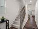 Carpeted stairway featuring wooden handrail and iron spindles at 16022 Red Buckeye Ln, Huntersville, NC 28078