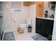 Well-lit bathroom featuring modern fixtures and a white-tiled wall at 1723 Oak St, Charlotte, NC 28269