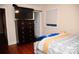 Modern bedroom with wood floors, mounted TV, and large window at 1723 Oak St, Charlotte, NC 28269